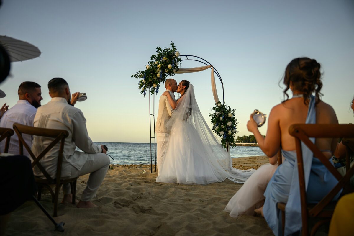 Couple embracing on the beach at sunset, Dominican Republic